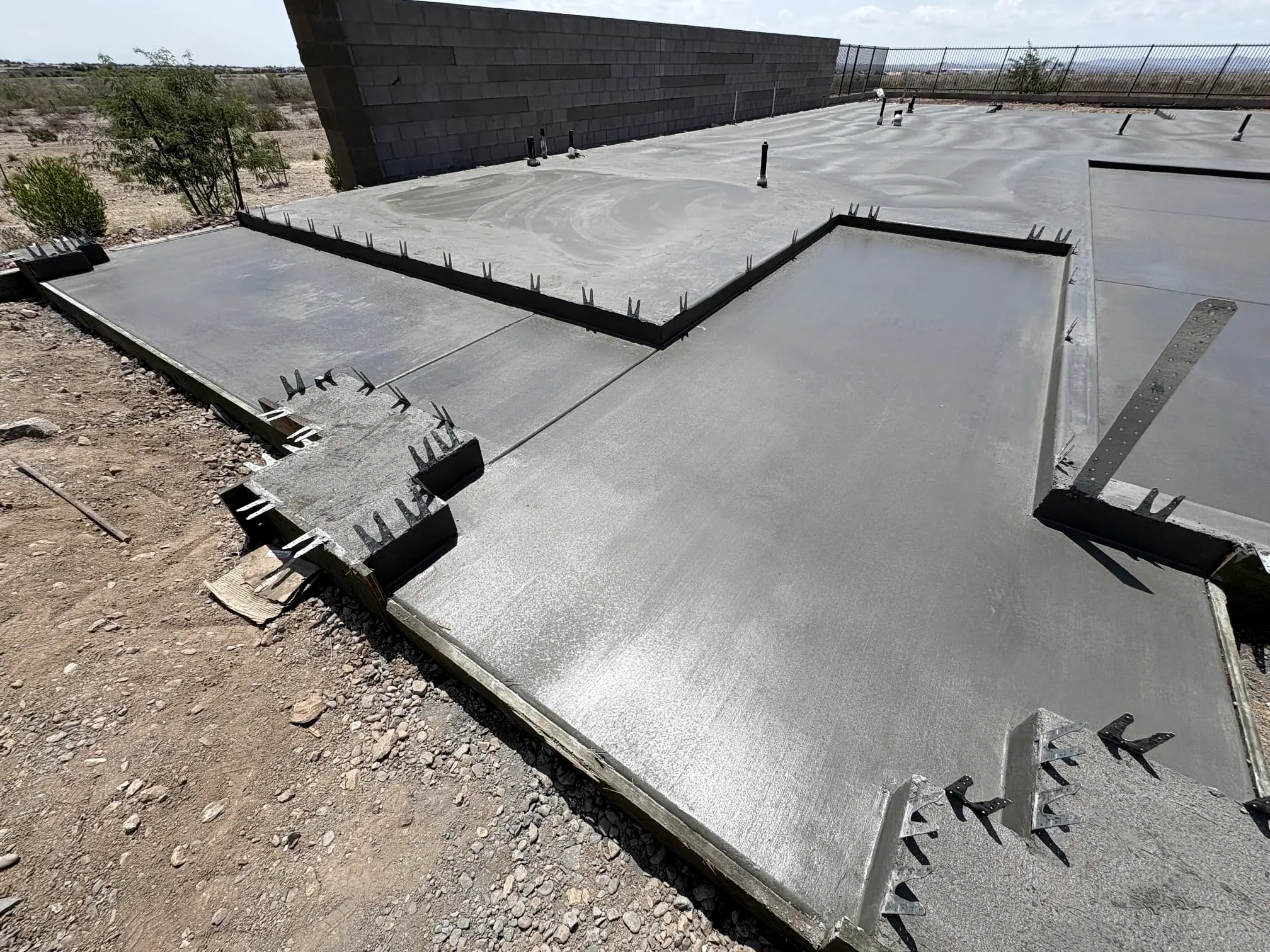 A stepped stem-wall slab poured against a block wall